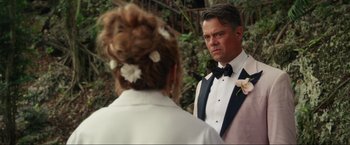 Movie still from “Shotgun Wedding” (2022), directed by Jason Moore – A man and a woman in tuxedos looking at each other; Close Up shot, Over the shoulder angle