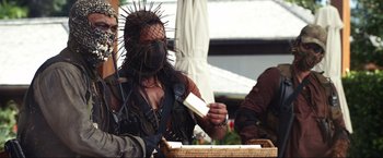 Movie still from “Shotgun Wedding” (2022), directed by Jason Moore – A person with a face mask on and a wig on; Medium shot, Over the shoulder angle