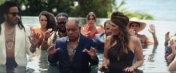 Movie still from “Shotgun Wedding” (2022), directed by Jason Moore – A group of people standing in a pool of water; Medium shot, High angle