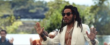 Movie still from “Shotgun Wedding” (2022), directed by Jason Moore – A man with dreads and a white jacket; Close Up shot, Over the shoulder angle