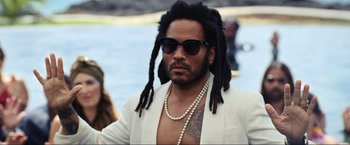 Movie still from “Shotgun Wedding” (2022), directed by Jason Moore – A man with dreads and a white jacket; Close Up shot, Over the shoulder angle