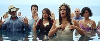 Movie still from “Shotgun Wedding” (2022), directed by Jason Moore – A group of people standing in a body of water; Medium shot, Over the shoulder angle