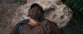 Movie still from “Shotgun Wedding” (2022), directed by Jason Moore – A man wearing a hat and a face mask; Close Up shot, Low angle