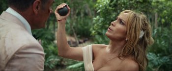 Movie still from “Shotgun Wedding” (2022), directed by Jason Moore – A woman holding an object up to her face; Close Up shot, Overhead angle