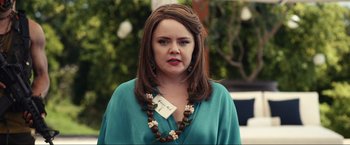 Movie still from “Shotgun Wedding” (2022), directed by Jason Moore – A woman wearing a necklace with flowers on it; Close Up shot, Over the shoulder angle