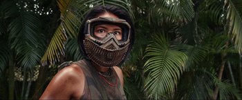 Movie still from “Shotgun Wedding” (2022), directed by Jason Moore – A woman wearing a helmet and goggles in the jungle; Close Up shot, Over the shoulder angle