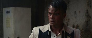 Movie still from “Shotgun Wedding” (2022), directed by Jason Moore – A person wearing a suit and tie; Close Up shot, Over the shoulder angle