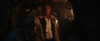 Movie still from “Shotgun Wedding” (2022), directed by Jason Moore – A man wearing a white and black shirt in the dark; Medium shot, Low angle