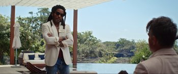 Movie still from “Shotgun Wedding” (2022), directed by Jason Moore – A man standing next to a body of water; Medium shot, Over the shoulder angle