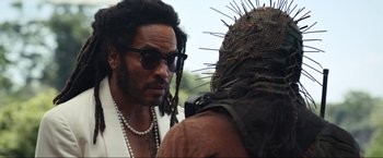 Movie still from “Shotgun Wedding” (2022), directed by Jason Moore – A person wearing a hat and sunglasses; Close Up shot, Over the shoulder angle