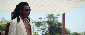 Movie still from “Shotgun Wedding” (2022), directed by Jason Moore – A man in a white jacket and sunglasses; Medium shot, Low angle