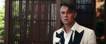 Movie still from “Shotgun Wedding” (2022), directed by Jason Moore – A person wearing a shirt and tie; Close Up shot, Over the shoulder angle