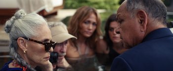 Movie still from “Shotgun Wedding” (2022), directed by Jason Moore – A group of people standing around a body of water; Medium shot, Over the shoulder angle