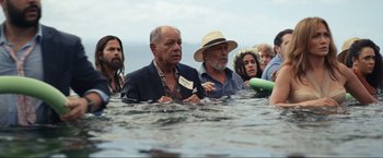 Movie still from “Shotgun Wedding” (2022), directed by Jason Moore – A group of people standing in the water; Medium shot, Over the shoulder angle