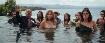 Movie still from “Shotgun Wedding” (2022), directed by Jason Moore – A group of people standing in the water in the ocean; Wide shot, High angle