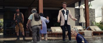 Movie still from “Shotgun Wedding” (2022), directed by Jason Moore – A group of people standing on top of a stage; Wide shot, Over the shoulder angle