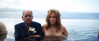 Movie still from “Shotgun Wedding” (2022), directed by Jason Moore – A man and a woman sitting in a body of water; Medium shot, Over the shoulder angle