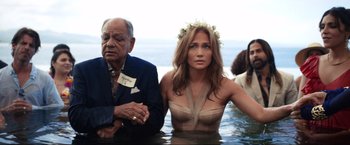 Movie still from “Shotgun Wedding” (2022), directed by Jason Moore – A man and a woman sitting in the water; Medium shot, High angle