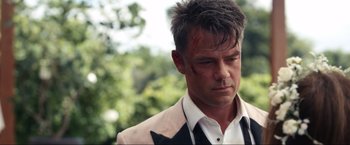 Movie still from “Shotgun Wedding” (2022), directed by Jason Moore – A person wearing a suit and tie; Close Up shot, Over the shoulder angle