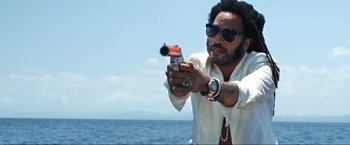 Movie still from “Shotgun Wedding” (2022), directed by Jason Moore – A man holding a gun while standing on top of a boat; Close Up shot, Low angle