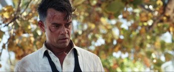 Movie still from “Shotgun Wedding” (2022), directed by Jason Moore – A person wearing a shirt and tie; Close Up shot, Over the shoulder angle