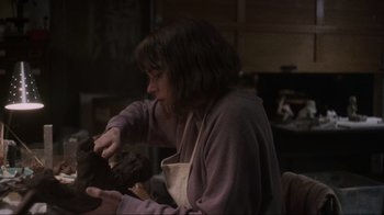 Movie still from “Showing Up” (2022), directed by Kelly Reichardt – A woman is holding something in her hands; Close Up shot, Over the shoulder angle