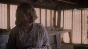 Movie still from “Showing Up” (2022), directed by Kelly Reichardt – A woman standing in the middle of an unfinished room; Medium shot, Over the shoulder angle