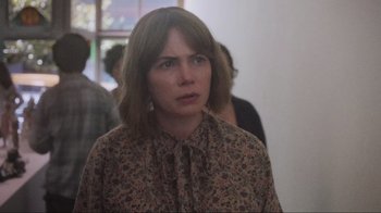 Movie still from “Showing Up” (2022), directed by Kelly Reichardt – A woman in a floral shirt looking to her left; Close Up shot, Over the shoulder angle