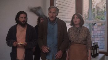 Movie still from “Showing Up” (2022), directed by Kelly Reichardt – An older man standing in front of a group of people; Medium shot, Low angle