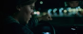 Movie still from “Sick” (2022), directed by John Hyams – A person sitting in a car at night; Close Up shot, Over the shoulder angle