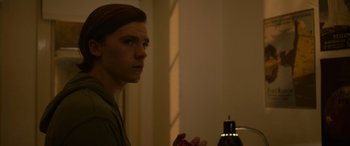 Movie still from “Sick” (2022), directed by John Hyams – A man standing in front of a bathroom mirror; Close Up shot, Low angle