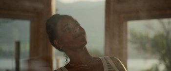 Movie still from “Sick” (2022), directed by John Hyams – A woman is looking up at the sky; Close Up shot, Low angle