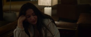 Movie still from “Sick” (2022), directed by John Hyams – A woman sitting in a room with her head turned to the side; Close Up shot, Over the shoulder angle