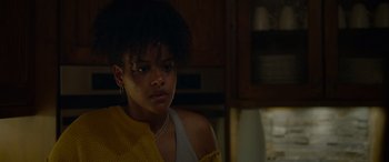 Movie still from “Sick” (2022), directed by John Hyams – A young woman in a yellow shirt is looking at the camera; Close Up shot, Over the shoulder angle