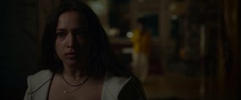 Movie still from “Sick” (2022), directed by John Hyams – A woman with long brown hair wearing a white shirt; Close Up shot, Over the shoulder angle