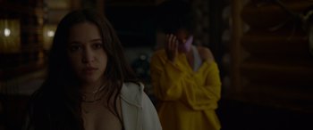 Movie still from “Sick” (2022), directed by John Hyams – Two women are standing in a dark room; Close Up shot, Over the shoulder angle