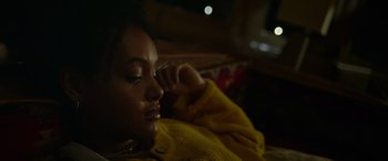 Movie still from “Sick” (2022), directed by John Hyams – A woman laying on a bed with her hand on her face; Close Up shot, Over the shoulder angle