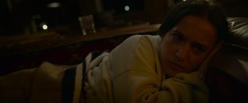 Movie still from “Sick” (2022), directed by John Hyams – A person laying on the ground in a room; Close Up shot, High angle