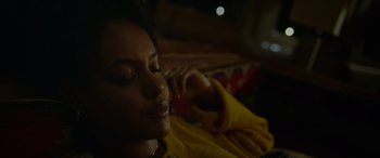 Movie still from “Sick” (2022), directed by John Hyams – A person laying on a couch with their eyes closed; Close Up shot, Low angle