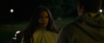 Movie still from “Sick” (2022), directed by John Hyams – A woman in a yellow jacket is looking at the camera; Close Up shot, Over the shoulder angle