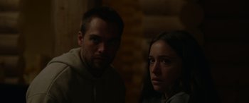 Movie still from “Sick” (2022), directed by John Hyams – A man and a woman standing next to each other; Close Up shot, Low angle