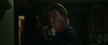 Movie still from “Sick” (2022), directed by John Hyams – A man holding a remote control in a dark room; Close Up shot, Low angle