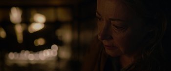 Movie still from “Sick” (2022), directed by John Hyams – A person looking down at the ground; Close Up shot, Over the shoulder angle