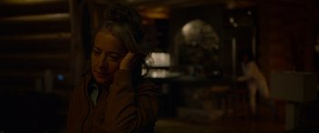 Movie still from “Sick” (2022), directed by John Hyams – A woman sitting in front of a window with her hand on her head; Close Up shot, Over the shoulder angle