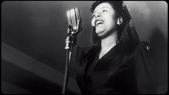 Movie still from “Sidney” (2022), directed by Reginald Hudlin – An old photo of a woman singing into a microphone; Close Up shot, Low angle