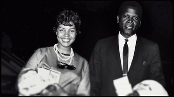 Movie still from “Sidney” (2022), directed by Reginald Hudlin – An old black and white photo of a man and a woman; Medium shot, Low angle