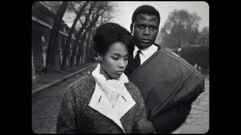 Movie still from “Sidney” (2022), directed by Reginald Hudlin – A man and woman standing next to each other on the street; Medium shot, Low angle