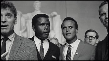 Movie still from “Sidney” (2022), directed by Reginald Hudlin – A black and white photo of two men standing next to each other; Close Up shot, Low angle