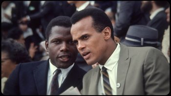 Movie still from “Sidney” (2022), directed by Reginald Hudlin – A couple of men standing next to each other; Close Up shot, Low angle