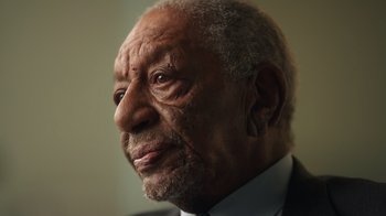 Movie still from “Sidney” (2022), directed by Reginald Hudlin – An older man wearing a suit and tie looking to his left; Extreme Close Up shot, Low angle